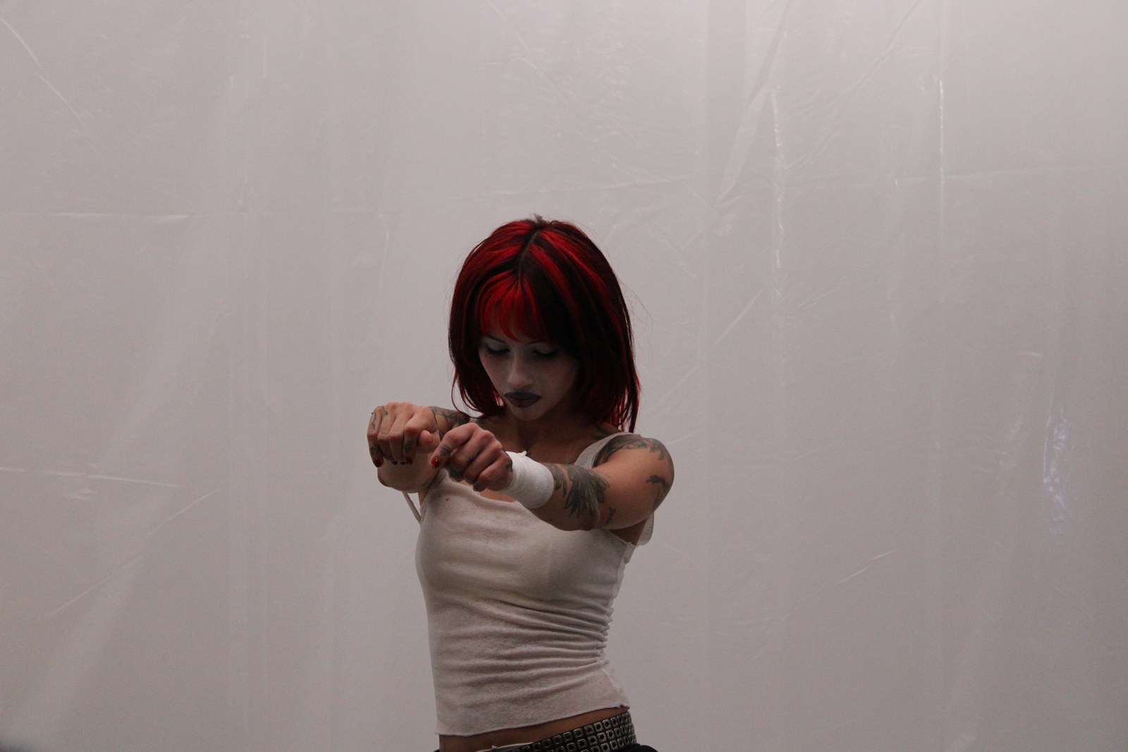 Melodie mid-motion in the plastic-wrapped listening room.